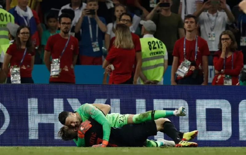 Croatia's midfielder Ivan Rakitic celebrates with Croatia's goalkeeper Danijel Subasic during the Russia 2018 World Cup quarter-final football match between Russia and Croatia at the Fisht Stadium in Sochi on July 7, 2018.
Croatia beat Russia 4-3 on penalties on Saturday to set up a World Cup semi-final against England after a dramatic match full of twists and turns. / AFP PHOTO / Adrian DENNIS / RESTRICTED TO EDITORIAL USE - NO MOBILE PUSH ALERTS/DOWNLOADS