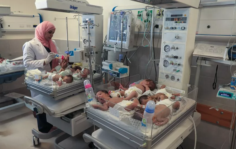 A Palestinian medic cares for premature babies, evacuated from Gaza City's Al Shifa hospital, ahead of their transfer from a hospital in Rafah in the southern Gaza Strip to Egypt, on November 20, 2023, amid ongoing battles between Israel and the militant group Hamas. Twenty-nine premature babies arrived in Egypt on November 20, Egyptian media said, after their evacuation from Gaza's largest hospital which has become a focal point of Israel's war with Hamas. (Photo by SAID KHATIB / AFP) / The erroneous DATE appearing in the metadata of this photo by SAID KHATIB has been modified in AFP systems in the following manner: [November 20] instead of [November 19]. Please immediately remove the erroneous mention[s] from all your online services and delete it (them) from your servers. If you have been authorized by AFP to distribute it (them) to third parties, please ensure that the same actions are carried out by them. Failure to promptly comply with these instructions will entail liability on your part for any continued or post notification usage. Therefore we thank you very much for all your attention and prompt action. We are sorry for the inconvenience this notification may cause and remain at your disposal for any further information you may require.