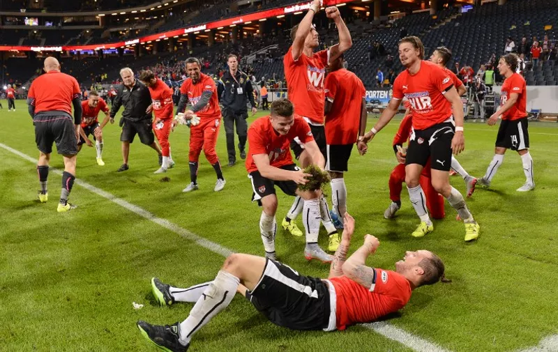 Players of Austria celebrate after winning the Euro 2016 qualifying group G football match between Sweden and Austria at the Friends Arena in Solna, near Stockholm on September 8, 2015.