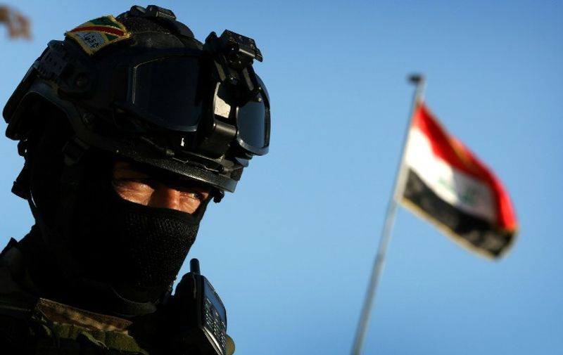 An Iraqi soldier stands guard at the entrance of the Nineveh base for liberation operations in Makhmur, about 280 kilometres (175 miles) north of the capital Baghdad, on February 11, 2016. 

The Iraqi army is deploying thousands of soldiers to a northern base in preparation for operations to retake the Islamic State (IS) group's hub of Mosul, according to officials, as IS still holds Fallujah, east of Ramadi, and Mosul, Iraq's second city that is located in the north. / AFP PHOTO / SAFIN HAMED