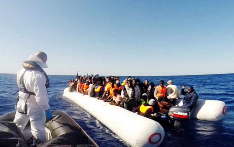 This handout video grab released by the Italian Coast Guard (Guardia Costiera) on May 2, 2015 shows a member of the Italian coast guard taking part in a rescue operation of 220 shipwrecked migrants on May 1, 2015, in the Mediterranean Sea, off the coast of Sicily. AFP PHOTO / GUARDIA COSTIERA
= RESTRICTED TO EDITORIAL USE - MANDATORY CREDIT "AFP PHOTO / GUARDIA COSTIERA" - NO MARKETING NO ADVERTISING CAMPAIGNS - DISTRIBUTED AS A SERVICE TO CLIENTS =