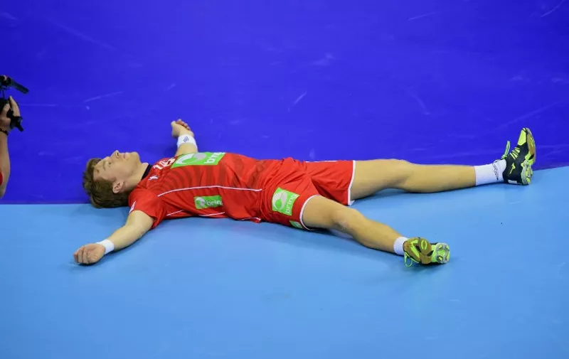 Kristian Bjørnsen of Norway lays in the hall after his team was defeated by Germany in the semi-final match of the Men's 2016 EHF European Handball Championship between Norway and Germany in Krakow on January 29, 2016.
Germany won the match 33:34 after extra time and qualified for the final. / AFP / ATTILA KISBENEDEK