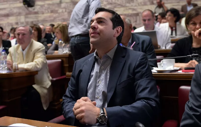 Greek Prime minister Alexis Tsipras attend a meeting of his parliamentary group at the Greek Parliament in Athens on July 10, 2015. Lawmakers in Greece are to vote whether to back a last-ditch reform plan the government submitted to creditors overnight in a bid to stave off financial collapse and exit from the eurozone. AFP PHOTO / LOUISA GOULIAMAKI