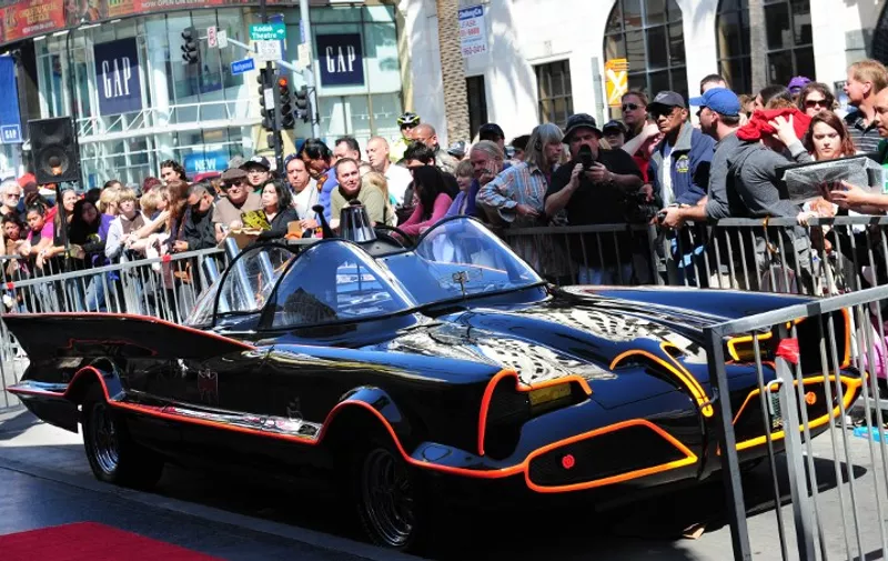 A crowd gathers around the Batmobile, cordoned off ahead of a ceremony for Adam West, who played Batman in the original TV series, for the unveiling of his star on Hollywood's Walk of Fame on April 5, 2012 in Hollywood, California.  In the early 1960s, Batman was simply a cartoon character in a comic book that was close to cancellation, but Adam Wests performance in the ground-breaking TV adaptation propelled Batman into becoming one of the most-famous characters in modern fiction. AFP PHOTO/Frederic J. BROWN