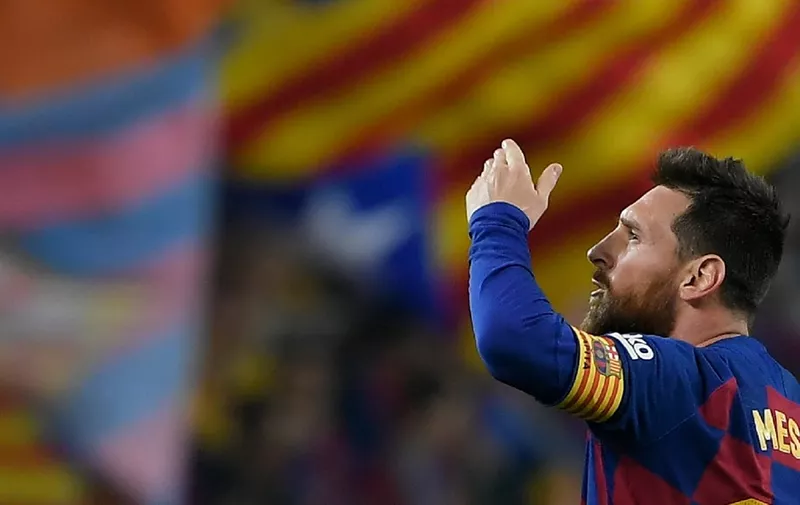 (FILES) In this file photo taken on October 29, 2019 Barcelona's Argentine forward Lionel Messi celebrates his goal during the Spanish league football match between FC Barcelona and Real Valladolid FC at the Camp Nou stadium in Barcelona. - Lionel Messi confirmed on September 4, 2020 he will stay at Barcelona, insisting he could never go to court against "the club of his life". Messi released a statement at 6pm CET, saying "I would never go to court against Barca because it is the club that I love, that gave me everything since I arrived, it is the club of my life, I have made my life here." (Photo by LLUIS GENE / AFP)