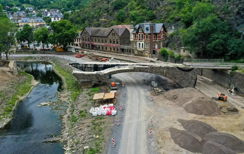 An aerial view taken on July 11, 2022 shows a destroyed bridge in Altenahr in Rhineland-Palatinate, western Germany, almost one year after the region was devastated by floods. - The dramatic floods of July 14 and 15, 2021 killed more than 220 people in Europe, leaving a trail of destruction in Germany and Belgium, and damage in the Netherlands, Austria and Switzerland.
After two days of torrential rain, flood waters carried away nearly everything in their path, devastating entire communities.
Western Germany was hit worst by the flooding. The state of Rhineland-Palatinate registered 49 deaths, while North Rhine-Westphalia said 135 were killed. One person died in Bavaria and in all, over 800 were injured. (Photo by Ina FASSBENDER / AFP)