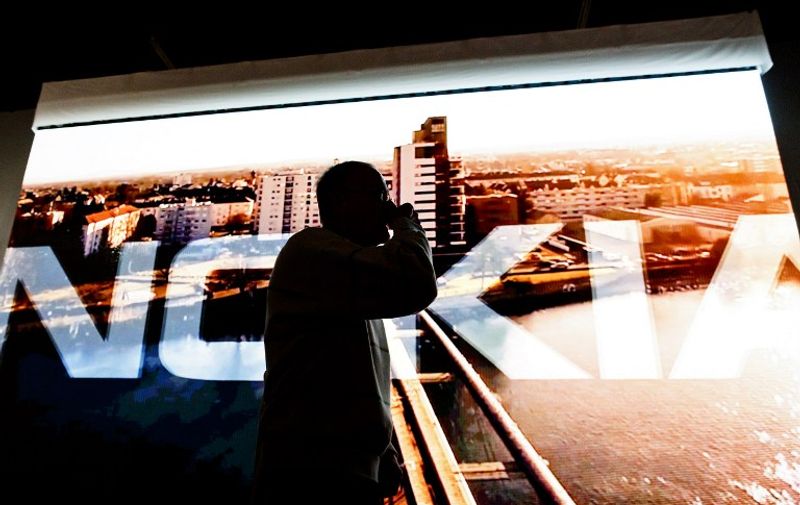 A screen with the title Nokia is pictured at the beginning of Finnish communications and information technology Nokia's Annual General Meeting in Helsinki, Finland, on May 5, 2015.  AFP PHOTO / LEHTIKUVA / Roni Rekomaa *** FINLAND OUT ***