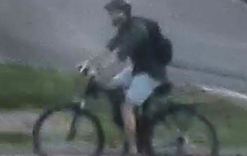 This handout video frame grab from a surveillance camera made available by the French National Police on their Twitter account on May 25, 2019 shows a male riding a mountain bike in the vicinity of a suspect package bomb blast that took place along a pedestrian street in the historic centre of Lyon, southeast France on May 24, 2019. - French police were on May 25, 2019 pulling out all the stops to locate a suspect following a blast in Lyon, France's third-bigest city, that wounded 13 people. The blast, which sources said might have used acetone peroxide, occurred two days ahead of hotly contested European Parliament elections and while France remains on edge owing to terrorist attacks which have rocked the country. (Photo by Handout / FRENCH POLICE / AFP) / RESTRICTED TO EDITORIAL USE - MANDATORY CREDIT "AFP PHOTO /FRENCH NATIONAL POLICE/ HANDOUT" - NO MARKETING - NO ADVERTISING CAMPAIGNS - DISTRIBUTED AS A SERVICE TO CLIENTS