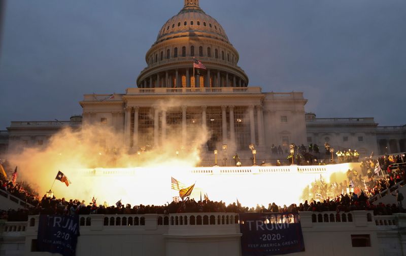 An explosion caused by a police munition is seen while supporters of U.S. President Donald Trump gather in front of the U.S. Capitol Building in Washington, U.S., January 6, 2021. REUTERS/Leah Millis - RC2M2L9E1RR3