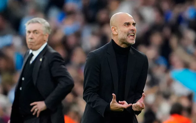 Manchester City's head coach Pep Guardiola reacts after Bernardo Silva scored the opening goal during the Champions League semifinal second leg soccer match between Manchester City and Real Madrid at Etihad stadium in Manchester, England, Wednesday, May 17, 2023. (AP Photo/Jon Super)