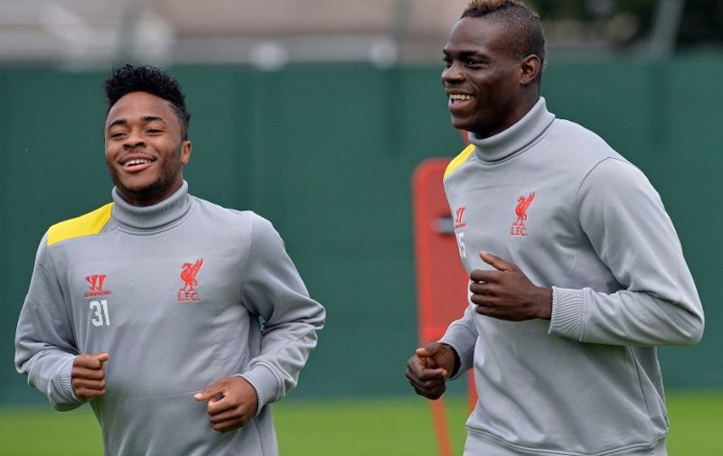 Liverpool's English midfielder Raheem Sterling (L) and Italian forward Mario Balotelli run during a training session at their Melwood training ground in Liverpool, north-west England, on September 15, 2014, ahead of their UEFA Champions League match against Ludogorets at Anfield. AFP PHOTO/PAUL ELLIS