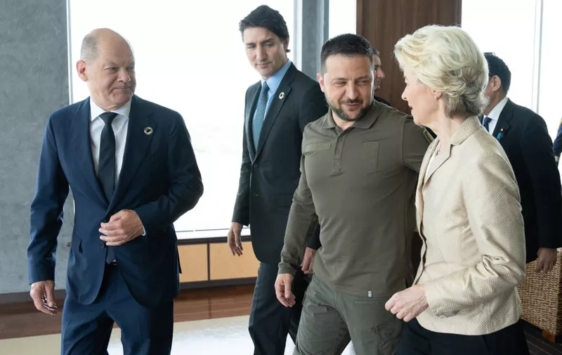 (L to R) Germany's Chancellor Olaf Scholz, Canada's Prime Minister Justin Trudeau, Ukraine's President Volodymyr Zelensky and European Commission President Ursula von der Leyen walk after posing for a family photo during the G7 Leaders' Summit in Hiroshima on May 21, 2023. (Photo by Stefan Rousseau / POOL / AFP)