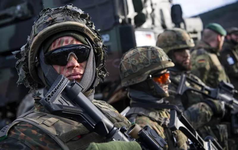 German soldiers are pictured at a static display during the Trident Juncture 2018, a NATO-led military exercise, on October 30, 2018 in Trondheim, Norway. - Trident Juncture 2018, is a NATO-led military exercise held in Norway from 25 October to 7 November 2018. The exercise is the largest of its kind in Norway since the 1980s. Around 50,000 participants from NATO and partner countries, some 250 aircraft, 65 ships and up to 10,000 vehicles take part in the exercise. The main goal of Trident Juncture is allegedly to train the NATO Response Force and to test the alliance's defence capability. (Photo by Jonathan NACKSTRAND / AFP)