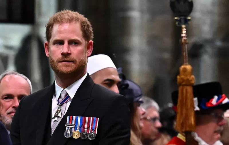 Britain's Prince Harry, Duke of Sussex looks on as Britain's King Charles III leaves Westminster Abbey after the Coronation Ceremonies in central London on May 6, 2023. - The set-piece coronation is the first in Britain in 70 years, and only the second in history to be televised. Charles will be the 40th reigning monarch to be crowned at the central London church since King William I in 1066. Outside the UK, he is also king of 14 other Commonwealth countries, including Australia, Canada and New Zealand. (Photo by Ben Stansall / POOL / AFP)