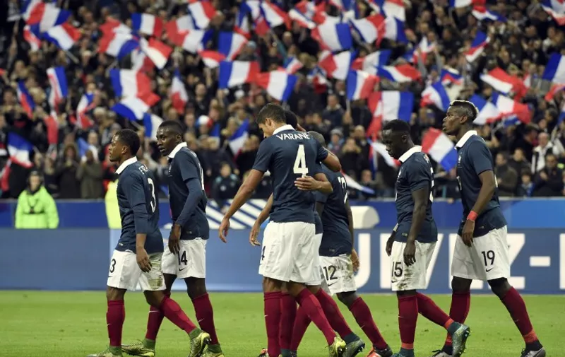 France's players celebrate after opening the scoring during a friendly international football match between France and Germany ahead of the Euro 2016, on November 13, 2015 at the Stade de France stadium in Saint-Denis, north of Paris.    AFP PHOTO / MIGUEL MEDINA / AFP / MIGUEL MEDINA