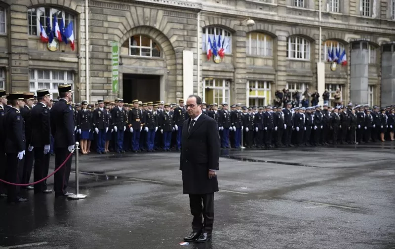French President Francois Hollande pays tribute to the victims of the Paris terror attacks during a visit to the French anti-terror security forces (Sentinelle) at the police headquarters, in Paris, on January 7, 2016, exactly one year after the attack targeting the French satirical newspaper Charlie Hebdo. The January 7, 2015 shootings at the Charlie Hebdo offices, which left 12 dead, were followed by an unprecedented series of killings in subsequent months that culminated in Islamic State attacks on Paris that left 130 dead. Hollande detailed plans toughening laws against organised crime and terrorism in his remarks to police.The reforms aim to introduce measures including more flexible rules of engagement for armed police and stronger stop-and-search powers.   AFP PHOTO / POOL /  MARTIN BUREAU / AFP / POOL / MARTIN BUREAU