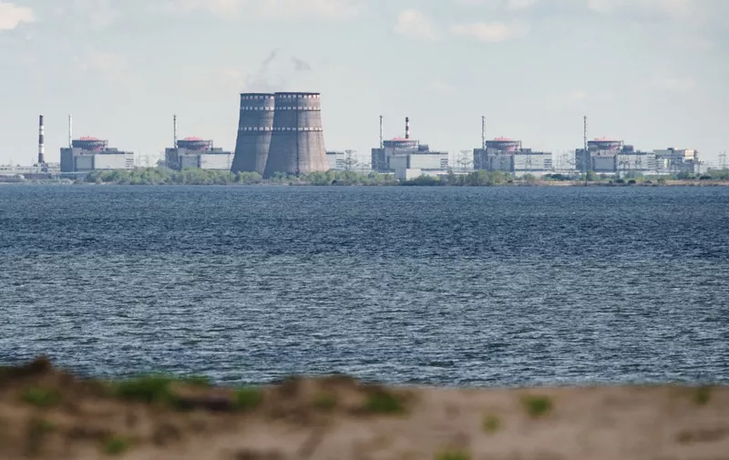 A general view shows the Zaporizhzhia nuclear power plant, situated in the Russian-controlled area of Enerhodar, seen from Nikopol in April 27, 2022. (Photo by Ed JONES / AFP)