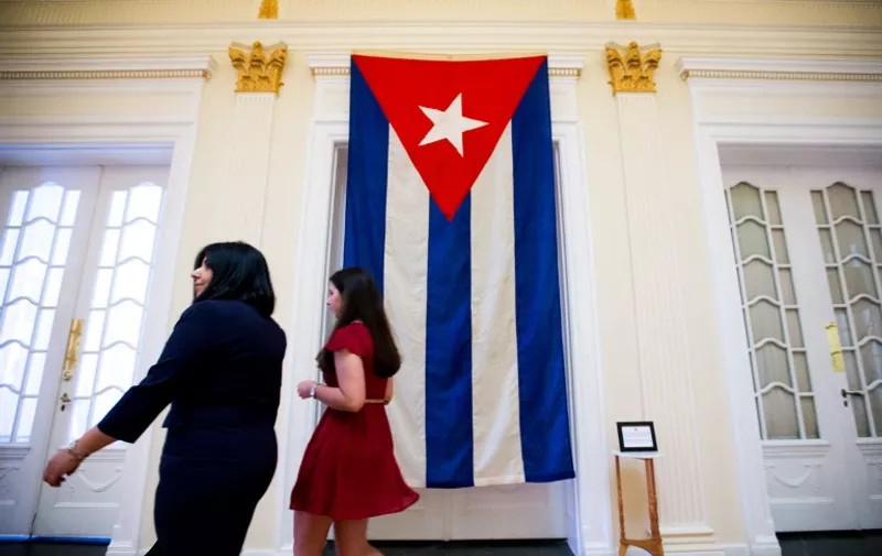 The last Cuban flag that was lowered from the Cuban Embassy in Washington on January 3, 1961 when relations between the United States and Cuba were severed, hangs in their new embassy in Washington, DC on July 20, 2015.The United States and Cuba formally resumed diplomatic relations on July 20, as the Cuban flag was raised at the US State Department in a historic gesture toward ending decades of hostility between the Cold War foes. AFP PHOTO / POOL / ANDREW HARNIK