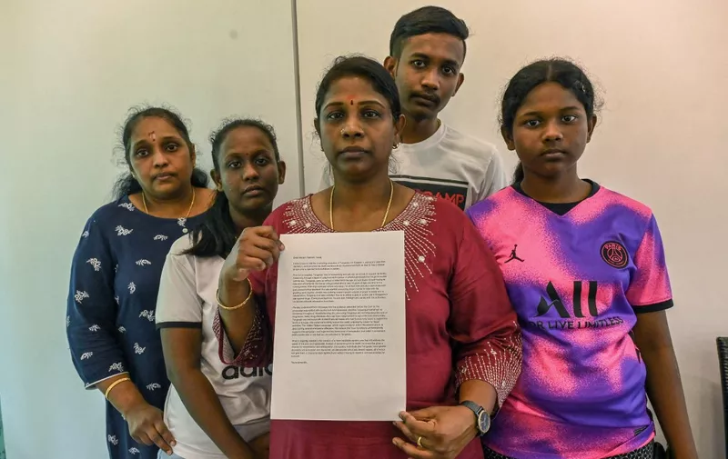 Leelavathy Suppiah (C), sister of a convicted drug trafficker Tangaraju Suppiah, who is scheduled for execution, poses with family members as she holds a petition letter to seek clemency in Singapore on April 23, 2023. - The family of a Singaporean man due to be hanged next week over a kilogram of cannabis pleaded for clemency from the authorities April 23 and urged a retrial. (Photo by Roslan RAHMAN / AFP)