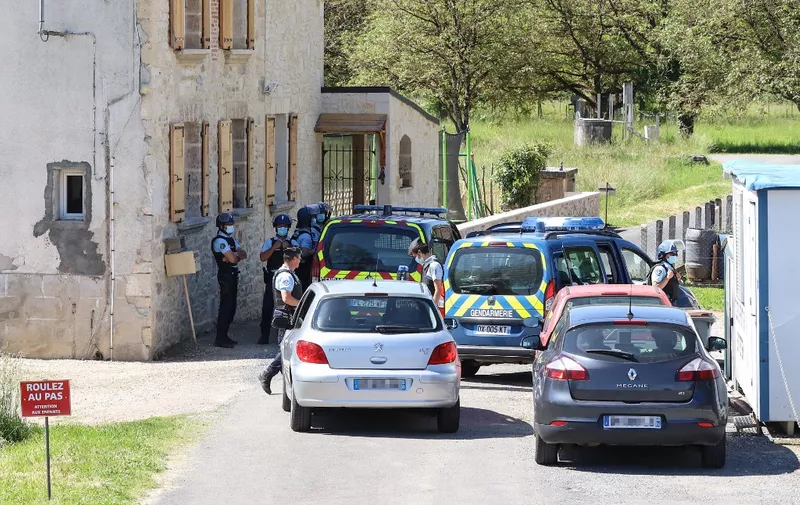 French gendarmes check vehicles during the manhunt of a heavily armed former soldier who allegedly opened fire on officers responding to a domestic violence dispute in Le Lardin-Saint-Lazare, near Sarlat, southwestern France, on May 30, 2021. - French police backed by helicopters hunted on May 30, 2021, for a heavily armed former soldier in southwestern France. Some 210 police officers and four helicopters were searching for the man, who has an electronic tag due to a prior domestic violence conviction, but who was still at large in the woods of the Dordogne region, authorities said. (Photo by Diarmid COURREGES / AFP)