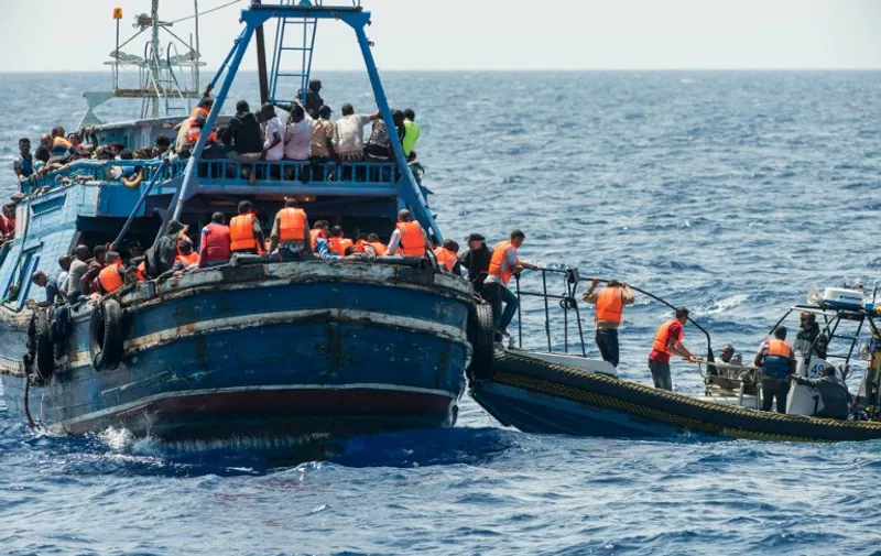 This handout picture released by the French NGO Medecins Sans Frontières (Doctors without borders - MSF) on August 27, 2015 shows migrants on a wooden boat during a rescue operation by MSF - MOAS and the Swedish Coast Guards "Poseidon" in the Meditterranean sea on August 26, 2015. At least 55 dead bodies were discovered during this operation on August 26, 2015 on three overcrowded migrant boats in the Mediterranean, the Italian coastguard said. Almost all of the victims -- 51 -- were found in the hold of a wooden boat found drifting precariously off the Libyan coast by Swedish coastguard vessel the Poseidon. Media reports said they had choked to death on gas fumes from the small motor boat. AFP PHOTO / GABRIELE FRANCOIS CASINI / MEDECINS SANS FRONTIERES
= RESTRICTED TO EDITORIAL USE -  MANDATORY CREDIT "AFP PHOTO / GABRIELE FRANCOIS CASINI / MEDECINS SANS FRONTIERES" - NO MARKETING NO ADVERTISING CAMPAIGNS NO ARCHIVES - DISTRIBUTED AS A SERVICE TO CLIENTS =