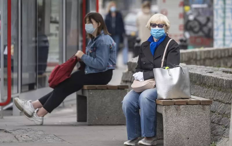 People wearing protective masks are seen on the streets of Warsaw after the Polish government tightened restrictions in the fight against the coronavirus and introduced mandatory mouth and nose coverage in public places, on October 10, 2020. - Polish senior citizens will once again be able to do their shopping without contact with the rest of the population, with shops reserved for them for two hours each day, the Polish Prime Minister announced on Saturday following record increases in contamination. (Photo by Wojtek RADWANSKI / AFP)