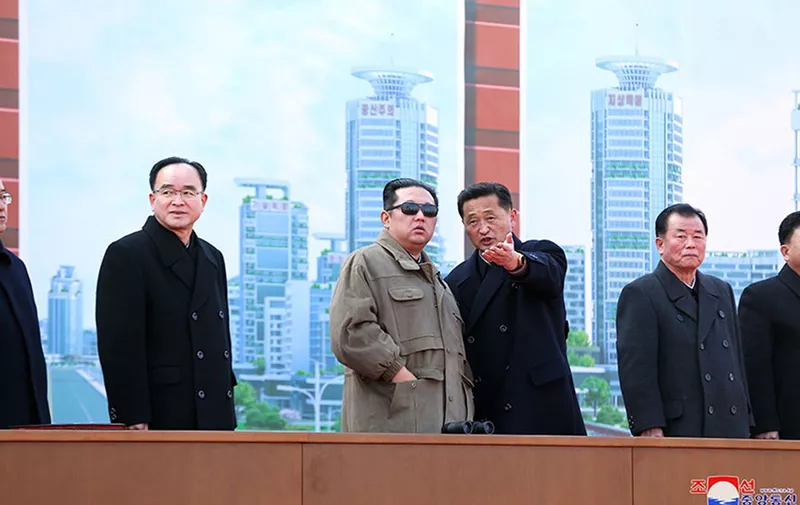 Kim Jong Un stands in front of an artistic rendering of the new Hwasong area skyscraper street at the groundbreaking ceremony in Pyongyang, North Korea. Top officials Jo Yong Won, Kim Tok Hun and O Su Yong (from left to right) joined him on the platform. North Korea officially opened construction Saturday on another street of ornate skyscrapers to address housing problems for 10,000 Pyongyang residents, according to state media, part of a wider plan introduced last year to build 50,000 homes in the capital by the end of 2025. Kim Jong Un told thousands of workers gathered at a groundbreaking ceremony to overcome mounting economic hardships and feel pride in helping build a bright socialist future, according to the Rodong Sinmun
Housing Project Ceremony, Pyongyang, North Korea - 13 Feb 2022,Image: 662170974, License: Rights-managed, Restrictions: , Model Release: no