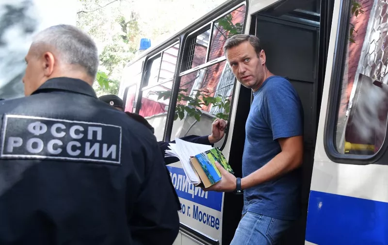 (FILES) Russian opposition leader Alexei Navalny steps out of a police bus as he arrives to the court for his trial in Moscow, on August 27, 2018. Russian opposition leader Alexei Navalny died on February 16, 2024 at the Arctic prison colony where he was serving a 19-year-term, Russia's federal penitentiary service said in a statement. (Photo by Vasily MAXIMOV / AFP)