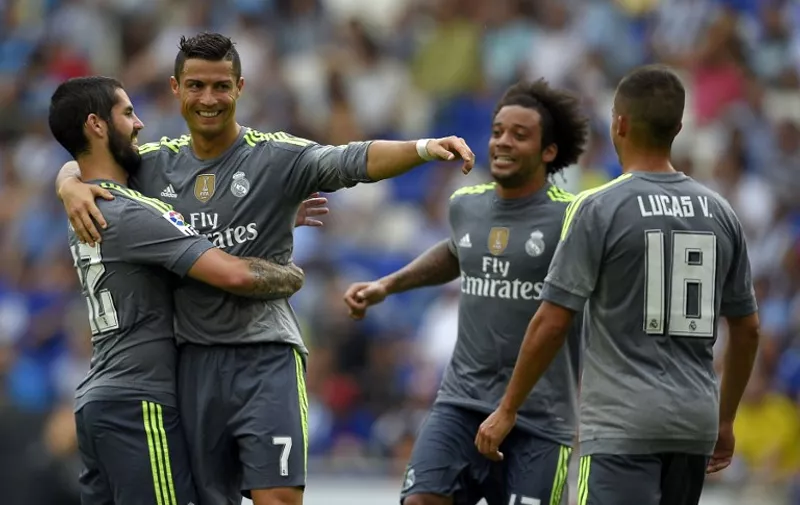 Real Madrid's Portuguese forward Cristiano Ronaldo (2ndL) celebrates with teammates Real Madrid's midfielder Isco (L) and Real Madrid's Brazilian defender Marcelo (2ndR) after scoring during the Spanish league football match RCD Espanyol vs Real Madrid CF at the Power8 stadium in Cornella de Llobregat on September 12, 2015. 