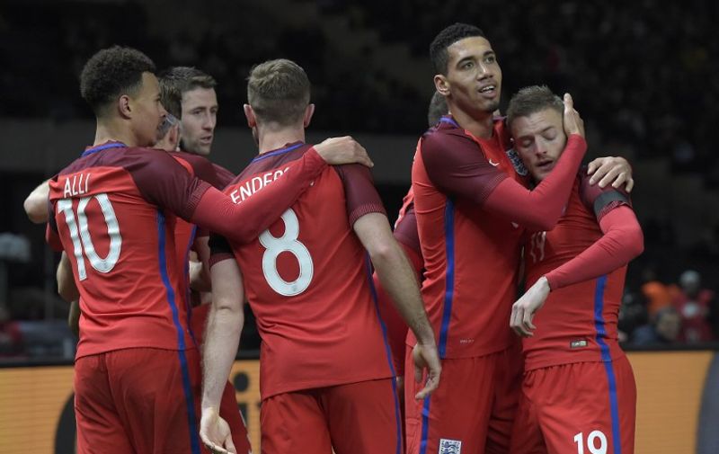 England's striker Jamie Vardy (R) celebrates with his teammates after scoring the 2-2 during the friendly football match Germany vs England at the Olympic Stadium in Berlin on March 26, 2016. / AFP / TOBIAS SCHWARZ