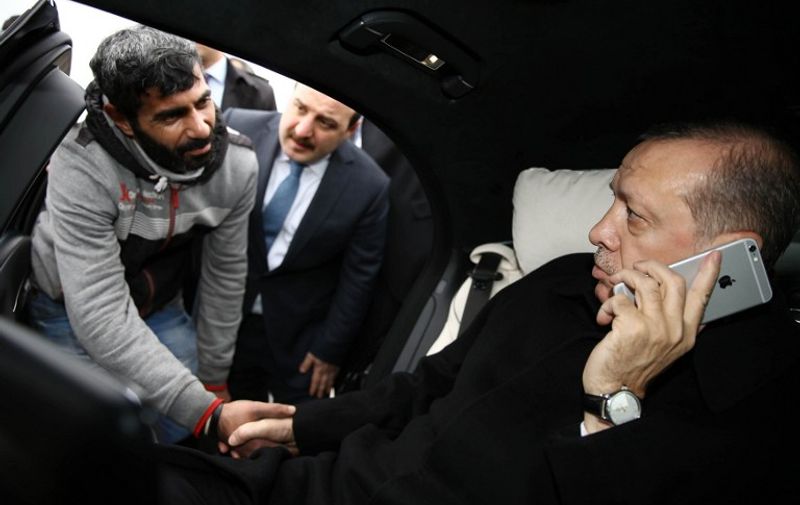 Turkish President Recep Tayyip Erdogan (R) shakes hands with a man who was allegedly about to attempt suicide off the Bosporus bridge in Istanbul, on December 25, 2015. 
Turkish President Recep Tayyip Erdogan used his celebrated rhetorical skills to save a life, preventing a man from jumping off Istanbul's Bosphorus Bridge. The man was apparently preparing to jump to his death when Erdogan's motorcade was passing over the bridge linking Europe with Asia after Friday prayers. 
 / AFP / YASIN BULBUL / RESTRICTED TO EDITORIAL USE - MANDATORY CREDIT "AFP PHOTO /TURKISH PRESIDENTIAL PRESS OFFICE/YAS?N BUBUL " - NO MARKETING NO ADVERTISING CAMPAIGNS - DISTRIBUTED AS A SERVICE TO CLIENTS