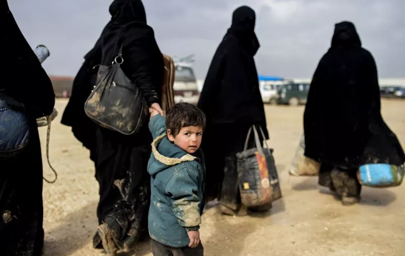 A boy arrives with women as Syrians fleeing the northern embattled city of Aleppo wait on February 6, 2016 in Bab al-Salama, near the city of Azaz, northern Syria, near the Turkish border crossing.
Thousands of Syrians were braving cold and rain at the Turkish border Saturday after fleeing a Russian-backed regime offensive on Aleppo that threatens a fresh humanitarian disaster in the country's second city. Around 40,000 civilians have fled their homes over the regime offensive, according to the Syrian Observatory for Human Rights monitor. / AFP / BULENT KILIC