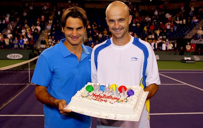 INDIAN WELLS, CA - MARCH 19: Roger Federer of Switzerland presents Ivan Ljubicic of Croatia a cake for his 29th birthday after their match during the Pacific Life Open at the Indian Wells Tennis Garden March 19, 2008 in Indian Wells, California.  (Photo by Matthew Stockman/Getty Images)