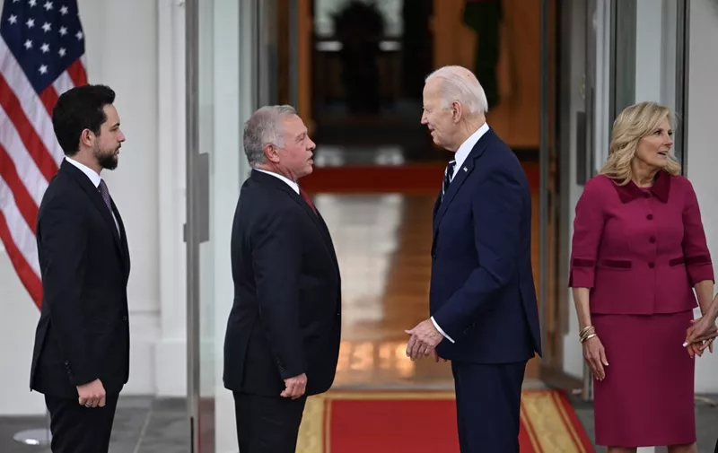 US President Joe Biden (C) greets King Abdullah II of Jordan (L) upon arrival at the White House in Washington, DC, on February 12, 2024. Also pictured is First Lady Jill Biden (R). The two leaders are to "discuss the ongoing situation in Gaza and efforts to produce an enduring end to the crisis," Press Secretary Karine Jean-Pierre said on February 8 in a statement. (Photo by Jim WATSON / AFP)