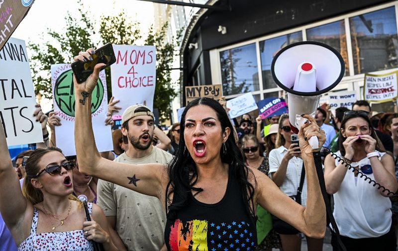 Abortion rights activists rally after the US Supreme Court striked down the right to abortion, in Miami, Florida, on June 24, 2022. (Photo by CHANDAN KHANNA / AFP)