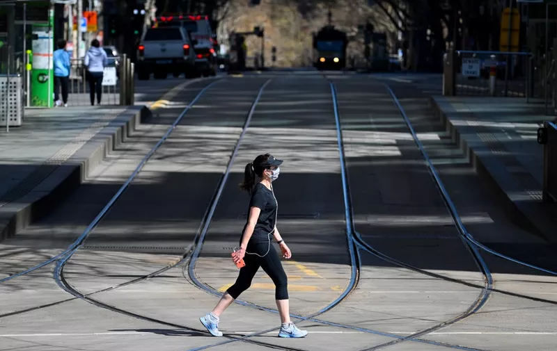 A woman takes a walk in Melbourne on September 6, 2020 as the state announced an extension to its strict lockdown law while it battles fresh outbreaks of the COVID-19 coronavirus. (Photo by William WEST / AFP)