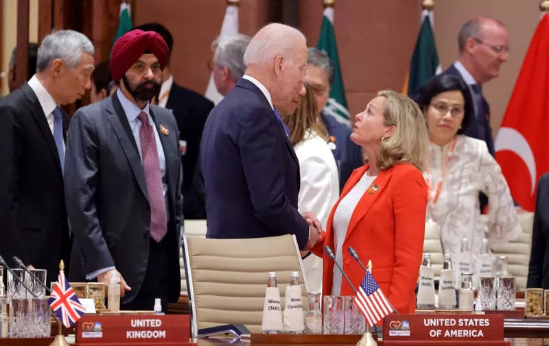 US President Joe Biden (C) speaks with Spain's Deputy Prime Minister Nadia Calvino upon their arrival to attend the opening session of the G20 Leaders' Summit in New Delhi on September 9, 2023. (Photo by Ludovic MARIN / POOL / AFP)