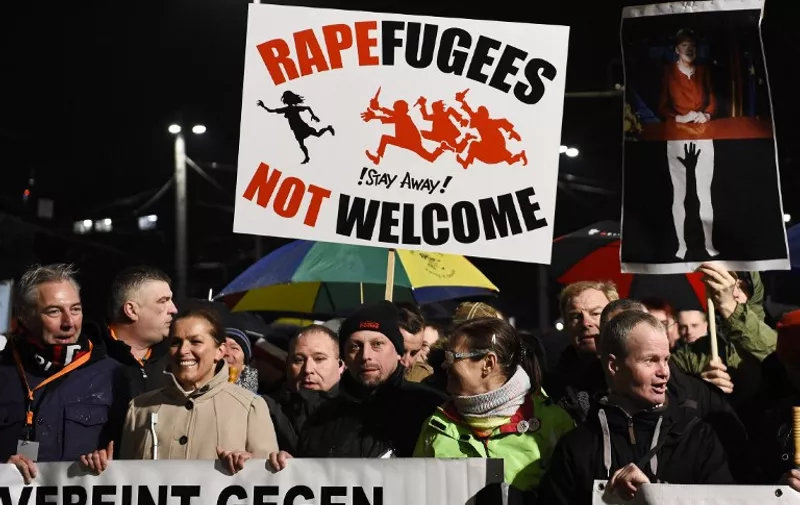 Protestors from the PEGIDA movement (Patriotic Europeans Against the Islamisation of the Occident) march during a rally in Leipzig on January 11, 2016.
Supporters of the xenophobic far-right movement PEGIDA gathered to mark the first year of the local chapter LEGIDA, as public anger runs high over the Cologne assaults. / AFP / TOBIAS SCHWARZ