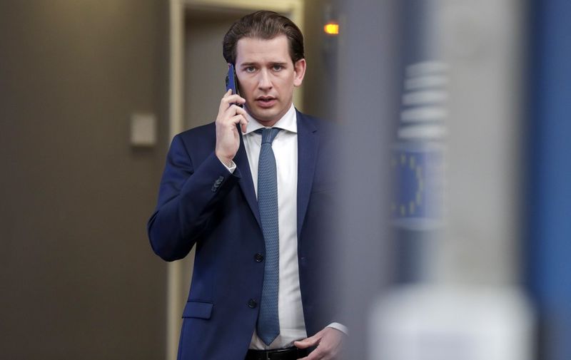 Austria's Chancellor Sebastian Kurz talks on the phone on the fourth day of an EU summit at the European Council building in Brussels, on July 20, 2020, as the leaders of the European Union hold their first face-to-face summit over a post-virus economic rescue plan. - The 27 EU leaders gather for another session of talks after three days and nights of prolonged wrangling failed to agree a 750-billion-euro ($860-billion) bundle of loans and grants to drag Europe out of the recession caused by the coronavirus pandemic (COVID-19). (Photo by STEPHANIE LECOCQ / POOL / AFP)