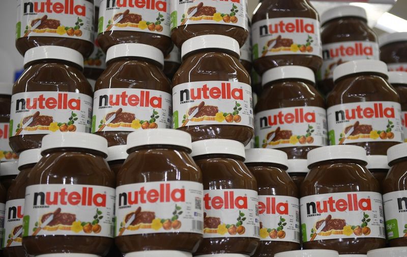 (FILES)A file photo taken on January 30, 2018  in Saint-Gregoire, near Rennes, northwest France, shows pots of the chocolate spread Nutella. - A plant in northern France that makes a quarter of the world's Nutella has been blockaded for a week by workers striking for more pay, unions said June 3, 2019, in troubling news for consumers of the cocoa and hazelnut spread. The stoppage has hit the Villers-Ecalles factory of privately-owned Italian confectionery giant Ferrero, which normally churns out 600,000 jars per day, making it the biggest Nutella producer in the world. (Photo by DAMIEN MEYER / AFP)