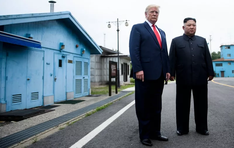 US President Donald Trump and North Korea's leader Kim Jong-un talk before a meeting in the Demilitarized Zone(DMZ) on June 30, 2019, in Panmunjom, Korea. (Photo by Brendan Smialowski / AFP)