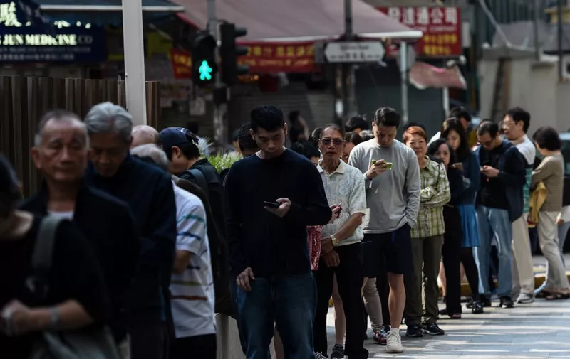 People queue to cast their vote during the district council elections in Wan Chai district of Hong Kong on November 24, 2019. - Hong Kong voted in district council elections in a ballot the city's pro-democracy movement hoped would send a message to the Beijing-backed government. (Photo by YE AUNG THU / AFP)