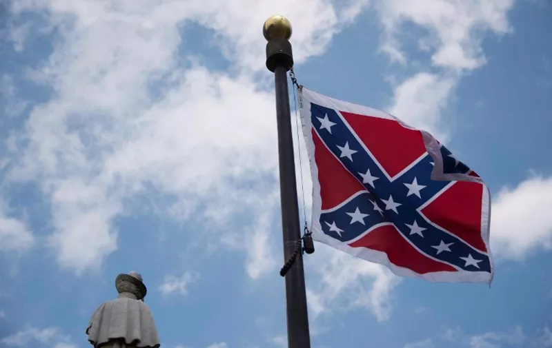 (FILES) In this June 27, 2015 file photo,the confederate flag flies on the grounds of the South Carolina State House in Columbia, South Carolina.  Lawmakers in South Carolina began debating July 6, 2015 whether to remove a Confederate flag in the state capital that has become a focal point of outrage after the Charleston church massacre. Senators opened the debate in the morning, and if two-thirds vote in favor of taking down the Civil War saltire, it will fall on the lower house of state representatives to give its approval as well. For 15 years, the Confederate battle flag has flown alongside a Confederate war memorial on the State House grounds in Columbia. AFP PHOTO/JIM WATSON
