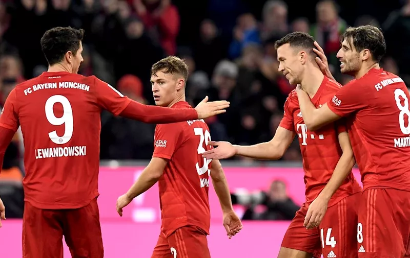 (L-R)  Bayern Munich's Polish striker Robert Lewandowski, Bayern Munich's midfielder Joshua Kimmich, Bayern Munich's Croatian midfielder Ivan Perisic and Bayern Munich's Spanish midfielder Javi Martinez react after the fourth goal for Munich during the German first division Bundesliga match between FC Bayern Munich and Borussia Dortmund in the stadium in Munich, southern Germany, on November 9, 2019. (Photo by Christof STACHE / AFP) / DFL REGULATIONS PROHIBIT ANY USE OF PHOTOGRAPHS AS IMAGE SEQUENCES AND/OR QUASI-VIDEO