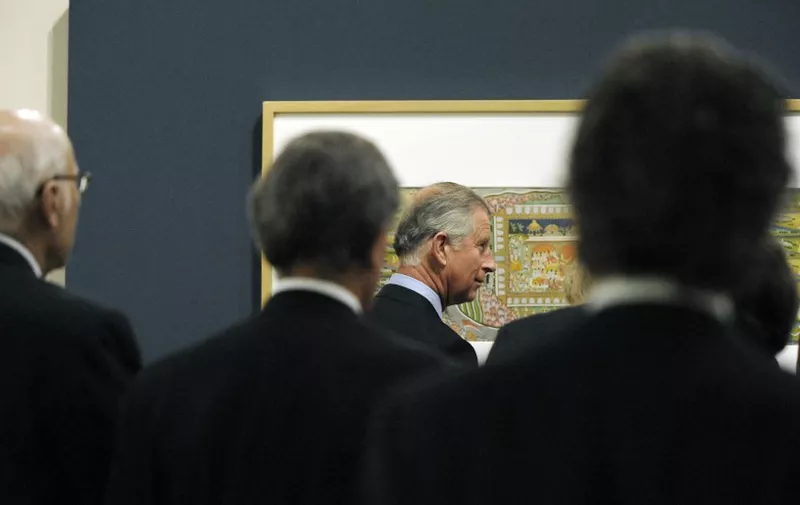 The Prince of Wales is seen through a crowd of guests while attending the opening of the Garden and Cosmos: The Royal Paintings of Jodhpur exhibition at The British Museum in London May 26, 2009. The exhibition features Indian royal court paintings ranging from the 17th to 19th century. The exhibition consists of 54 paintings from the royal collection at the Mehrangarh Museum Trust in Jodhpur, India. 
     AFP PHOTO / Adrian Dennis / WPA POOL (Photo by ADRIAN DENNIS / AFP)