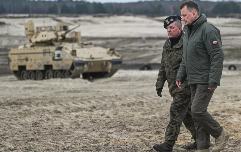 NOWA DEBA, POLAND - APRIL 12, 2023:
(L-R) Major General Maciej Jablonski with Mariusz Blaszczak, Deputy Prime Minister and Minister of National Defense joins Polish and American soldiers to witness a training session at Nowa Deba training ground, in Nowa Deba, Poland, on April 12 2023.
US and Polish soldiers team up at Nowa Deba to bolster NATO's eastern flank, backed by Poland's acquisition of 250 M1A2 Abrams tanks from the US Army. (Photo by Artur Widak/NurPhoto) (Photo by Artur Widak / NurPhoto / NurPhoto via AFP)