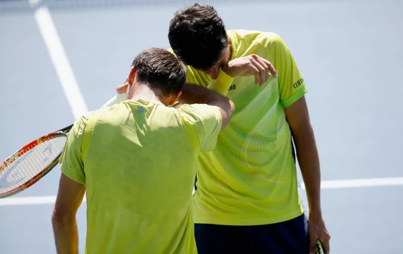CINCINNATI, OH - AUGUST 22: Ivan Dodig Croatia and Marcelo Melo of Brazil confer during during the men's doubles semifinals match against Marcin Matkowski of Poland and Nenad Zimonjic of Serbia of the Western &amp; Southern Open at the Linder Family Tennis Center on August 22, 2015 in Cincinnati, Ohio.   Rob Carr/Getty Images/AFP
