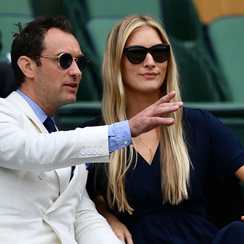 British actor Jude Law and partner Phillippa Coan sit in the royal box on centre court before the men's semi-final match on the tweflth day of the 2016 Wimbledon Championships at The All England Lawn Tennis Club in Wimbledon, southwest London, on July 8, 2016. (Photo by LEON NEAL / AFP) / RESTRICTED TO EDITORIAL USE
