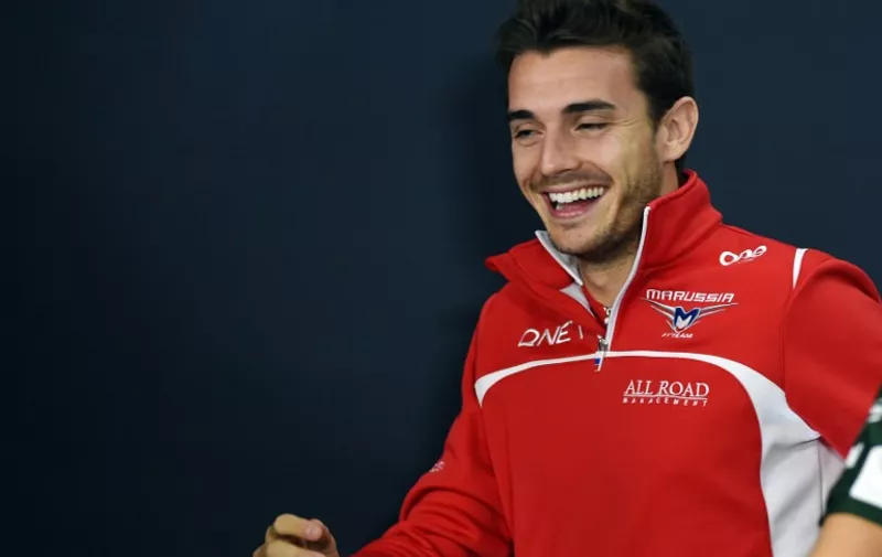 (FILES) This October 2, 2014 picture shows Marussia driver Jules Bianchi of France smiling after FIA official press conference for the Japanese Formula One Grand Prix in Suzuka.  French Formula One driver Jules Bianchi has died from head injuries he suffered in a crash at last October's Japanese Grand Prix, his family said on July 18, 2015.     AFP PHOTO / TOSHIFUMI KITAMURA