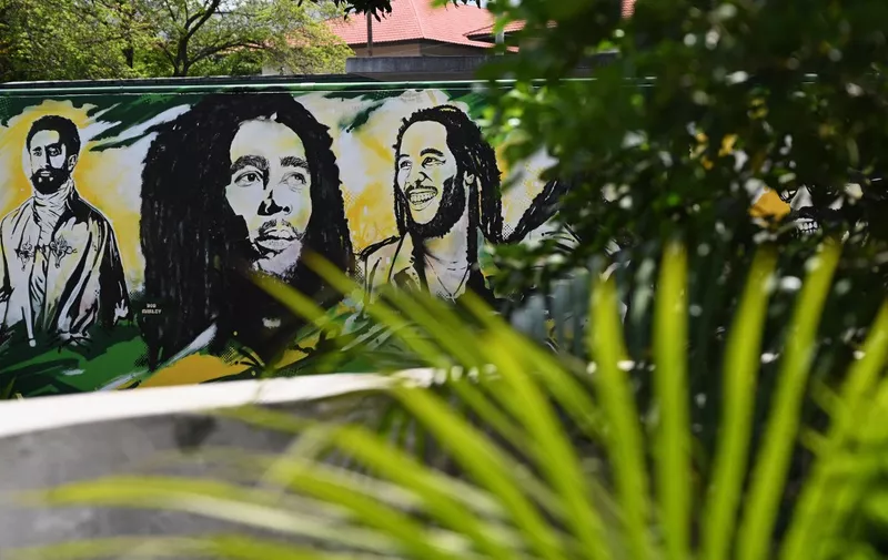 A mural depicting Ethiopian Emperor Haile Selassie I, Jamaican Reggae legend Bob Marley and Ziggy Marley on the grounds of the Bob Marley Museum in Kingston, Jamaica, on May 17, 2019. (Photo by Angela Weiss / AFP)